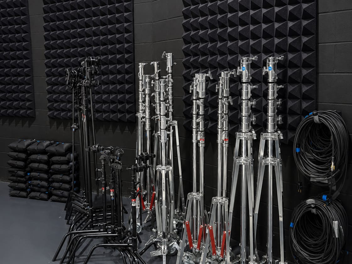 C-stands, combo stands, sandbags, and coiled cable staged at Viva Studios